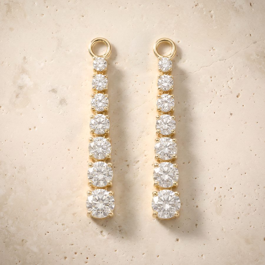 Diamond Earrings in 14K solid gold, graduated seven-stone drops on cream travertine